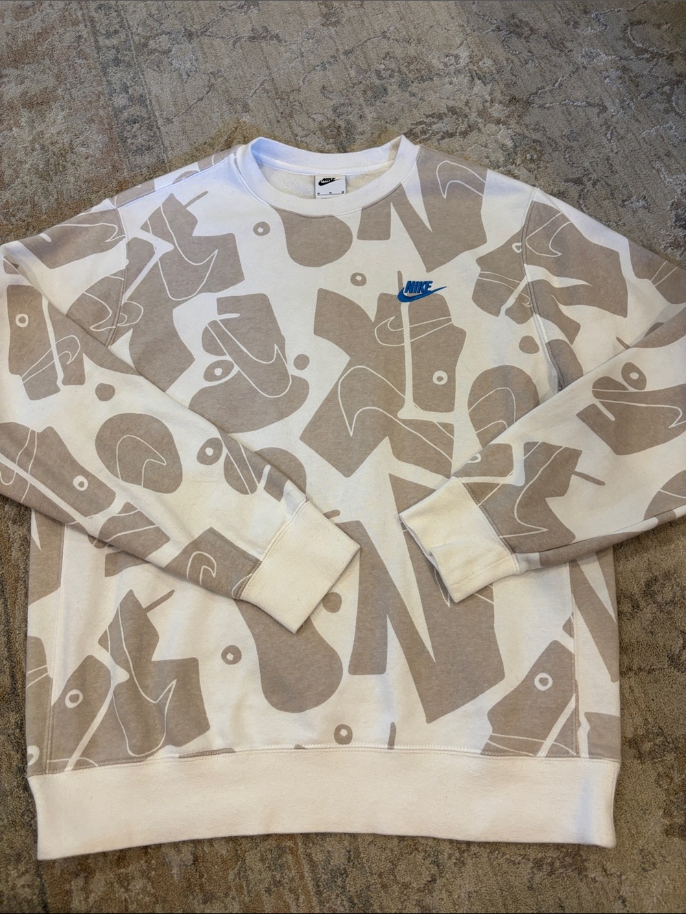 Nike Men’s White Crewneck Sweatshirt with Beige Abstract Print and Blue Logo